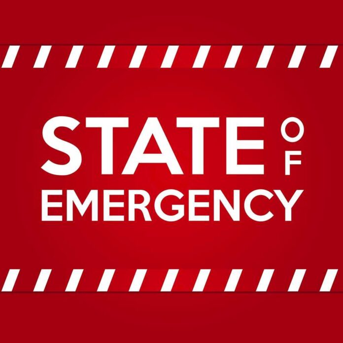 State,Of,Emergency,Banner.,White,Text,On,Red,Background,With