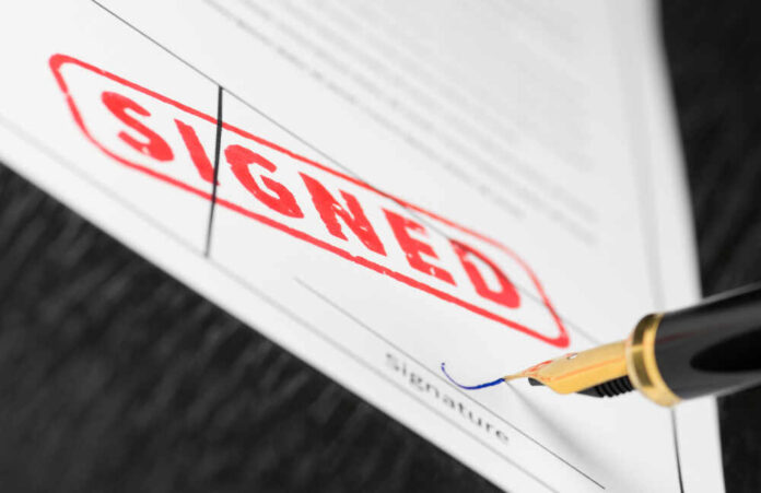 shutterstock_1187280247.jpg featured image Document signed with pen near signature line
