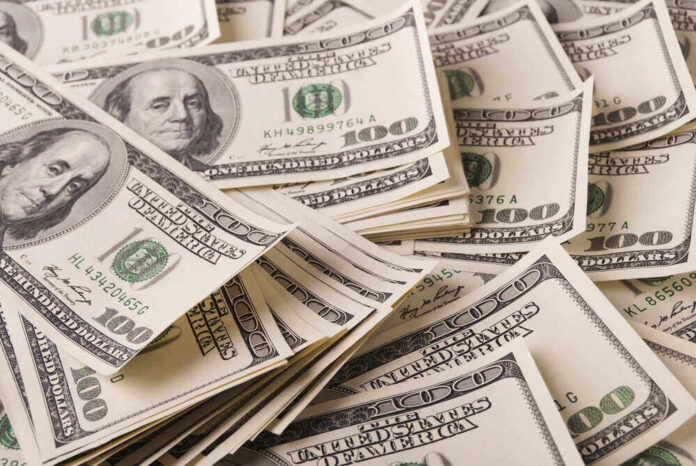 shutterstock_696138958.jpg featured image Stacks of one hundred dollar bills scattered.