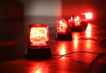 Red emergency lights on a dark floor