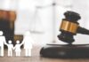 Gavel with family symbols and legal book background.