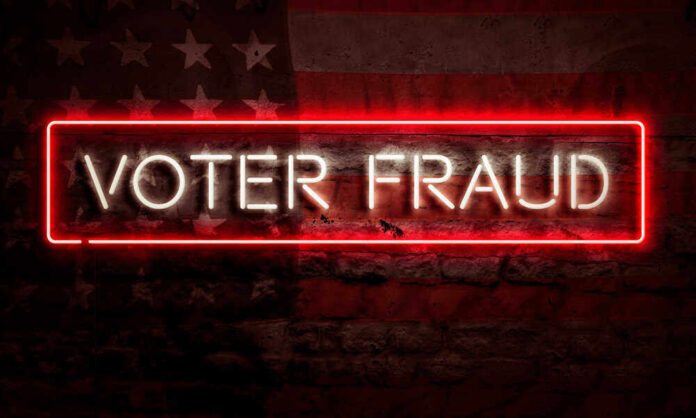 shutterstock_1794216790.jpg featured image Neon sign reading Voter Fraud on American flag background.
