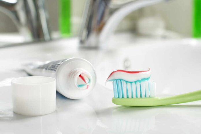 shutterstock_391977049.jpg featured image Toothbrush with toothpaste on sink counter