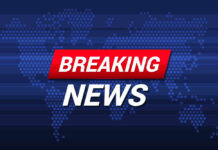 Breaking News text on world map background.