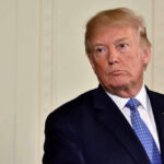 Trump Demands Killer’s Motive: Nation Awaits Answers Donald Trump in suit and tie