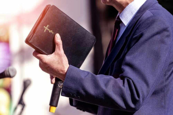 Man holding a Bible during a speech