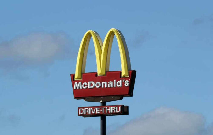 McDonald’s drive-thru sign against a blue sky