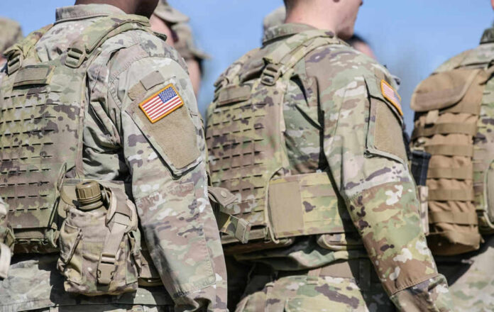 Soldiers in camouflage uniforms with American flag patches
