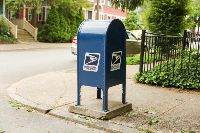 Blue USPS mailbox on a residential street corner