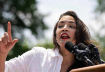 Alexandria Ocasio-Cortez speaking at an outdoor event