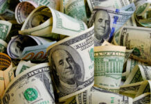 Rolled US dollar bills in various denominations