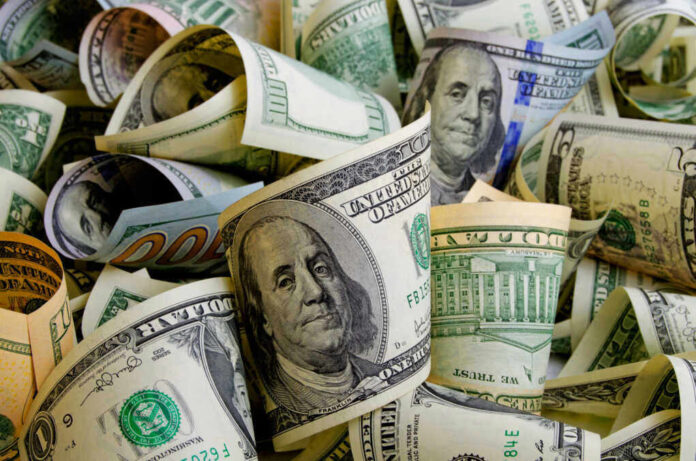 Rolled US dollar bills in various denominations