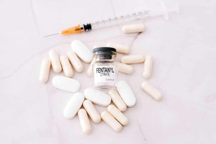 Fentanyl citrate vial surrounded by various pills and syringe