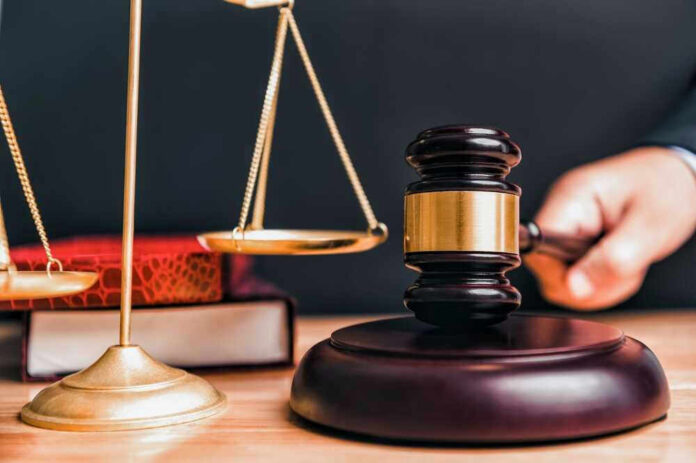 shutterstock_2314599993.jpg Judge gavel, scales of justice, and law books.