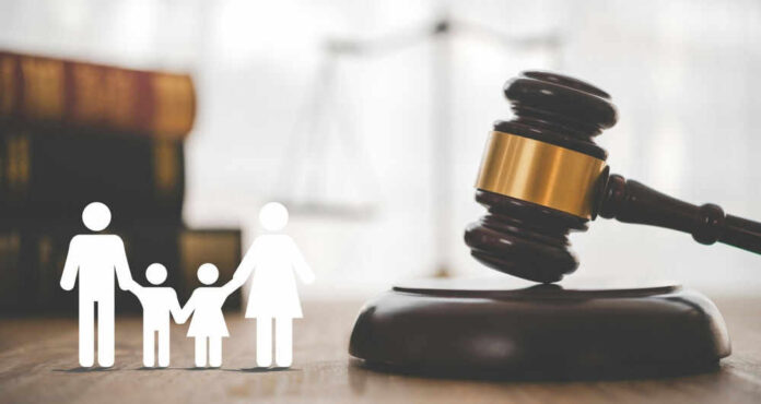 Gavel with family symbols and legal book background.