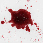 Red liquid splatter on a white background.