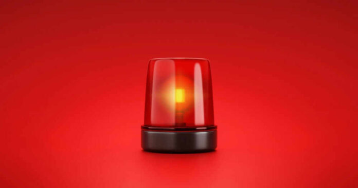 Red emergency light on red background