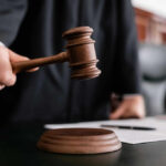 SHOCKING Courtroom Scheme — Judge Goes DOWN Judge holding gavel in courtroom.