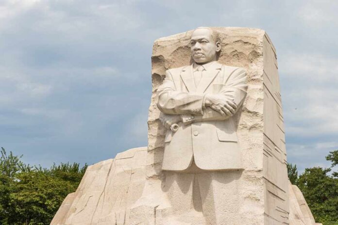Stone monument of Martin Luther King Jr. with arms crossed