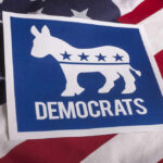 Democratic Party logo on American flag background.