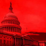 United States Capitol building under red-tinted sky.