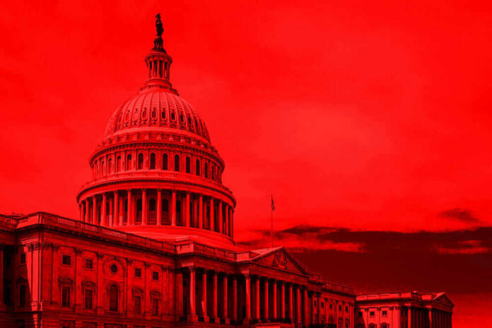 United States Capitol building under red-tinted sky.