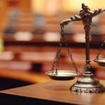 Texas Jury Stuns Nation with Controversial Decision Scales of justice in an empty courtroom.