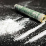 Cocaine Haul SHOCKER: Captain Finds, Sells, Busted! Cocaine lines with rolled banknote on surface