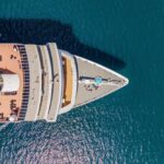 77-Year-Old Overboard: Cruise Chaos Unfolds Aerial view of a cruise ship's deck with sun loungers and a pool