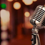 Massive Music Shift: Hip-Hop Faces New Rivals Vintage microphone on a blurred, warm-toned background.