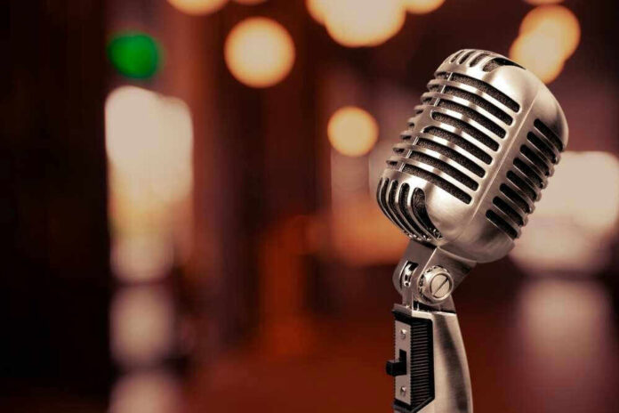 Vintage microphone on a blurred, warm-toned background.