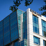 AMAZON PULLS PLUG On 72 Stores — Bombshell Details Modern office building with Amazon logo against sky