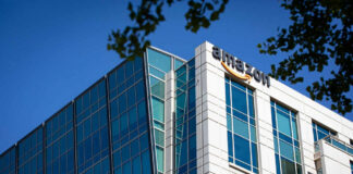 Modern office building with Amazon logo against sky