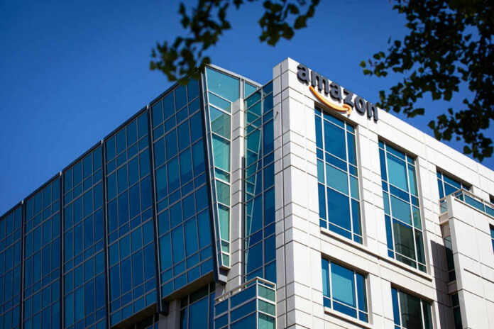 shutterstock_2523425061.jpg Modern office building with Amazon logo against sky
