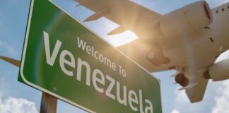 Welcome sign to Venezuela with an airplane flying overhead