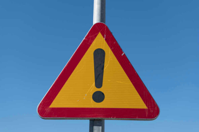 Triangular warning sign with exclamation mark.