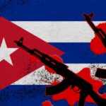 Cuban flag with silhouettes of guns and red splashes