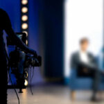 FCC Power Move Shakes ‘The View’ Person being filmed on a set with lights.