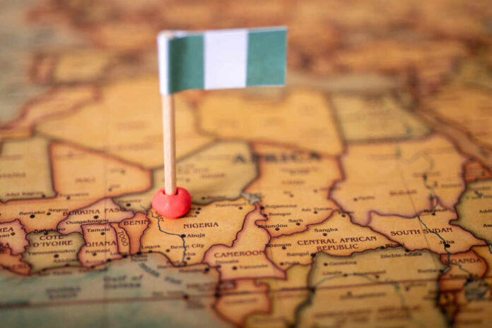 A small Nigerian flag placed on a map of Africa, highlighting Nigeria