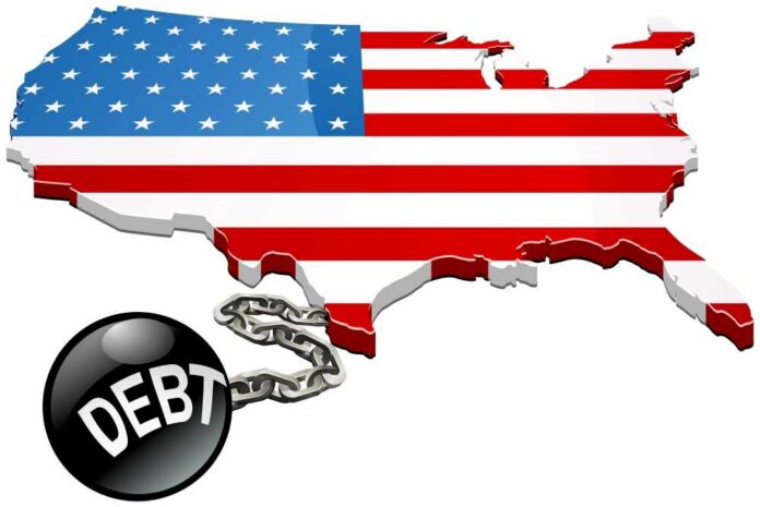 shutterstock_2135773885.jpg Map of the USA with an American flag design and a ball and chain labeled 'DEBT'