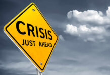 A yellow warning sign indicating a crisis ahead