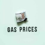 A bundle of cash next to the words 'GAS PRICES' on a light green background