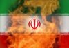 Iranian flag with flames in the background
