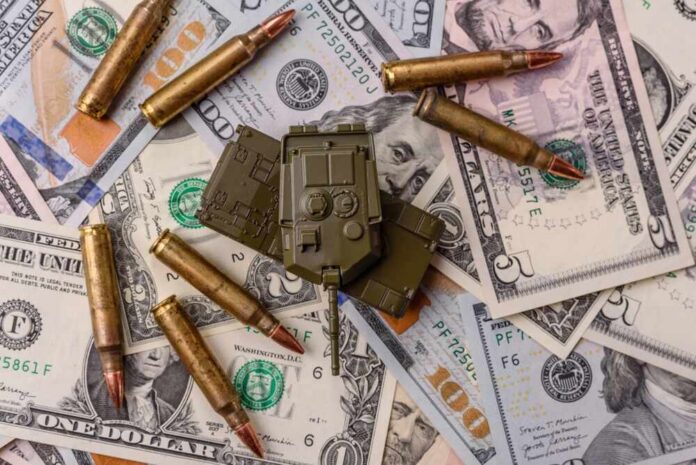A toy military vehicle surrounded by bullets and U.S. dollar bills