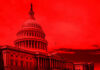United States Capitol building under red-tinted sky.