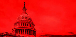 United States Capitol building under red-tinted sky.