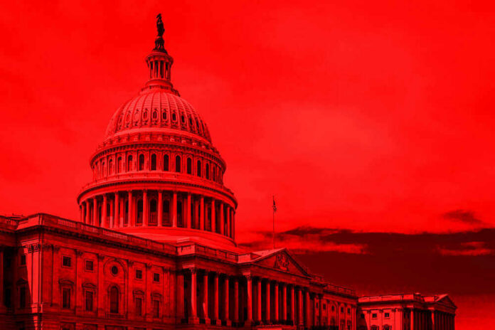 United States Capitol building under red-tinted sky.