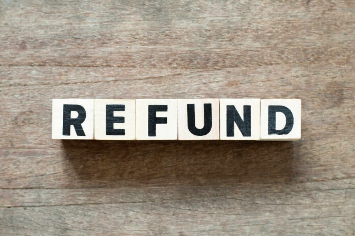 shutterstock_1276520449.jpg Wooden blocks spelling the word 'REFUND' on a wooden surface