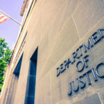 DOJ CAVES — Senator Forces Trump’s Hand Department of Justice building with American flag.