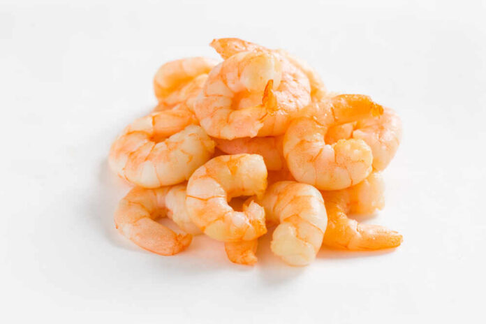 A pile of cooked shrimp on a white background